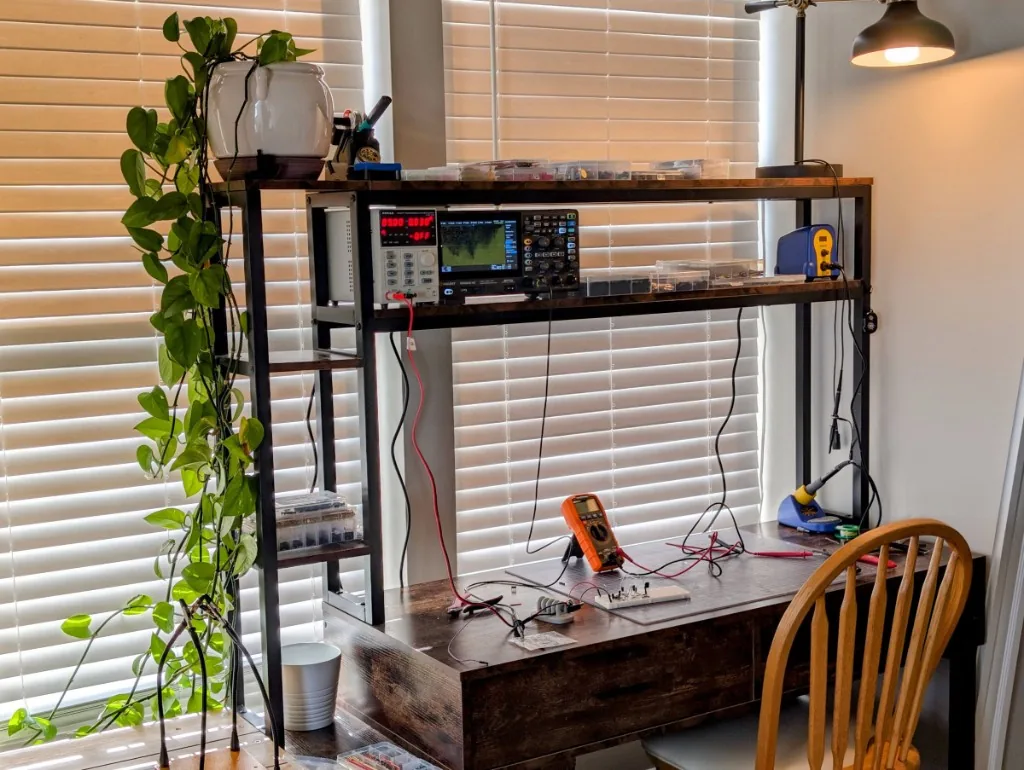 Travis Miller Design studio bench with test equipment and an in-progress circuit