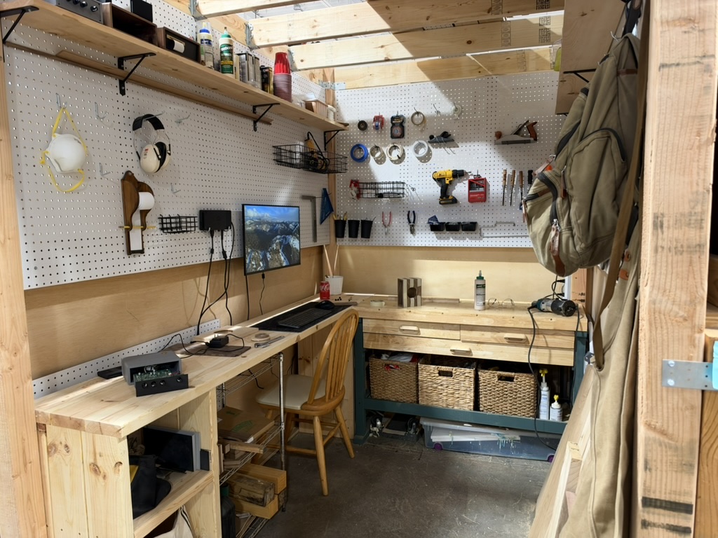 Travis Miller Design workshop with an electronics bench and woodworking tools