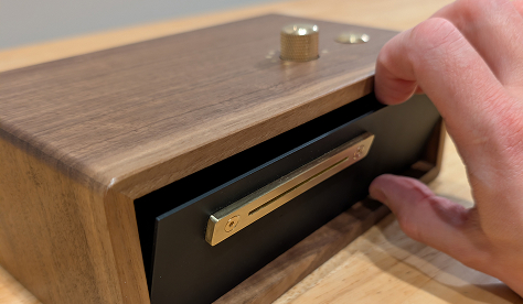 Removing the magnetic faceplate to change the paper roll